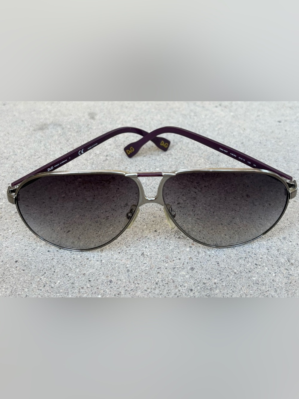 Dolce & Gabbana Womenโs Aviator Sunglasses Gray Lens Violet Arms Silver Frame